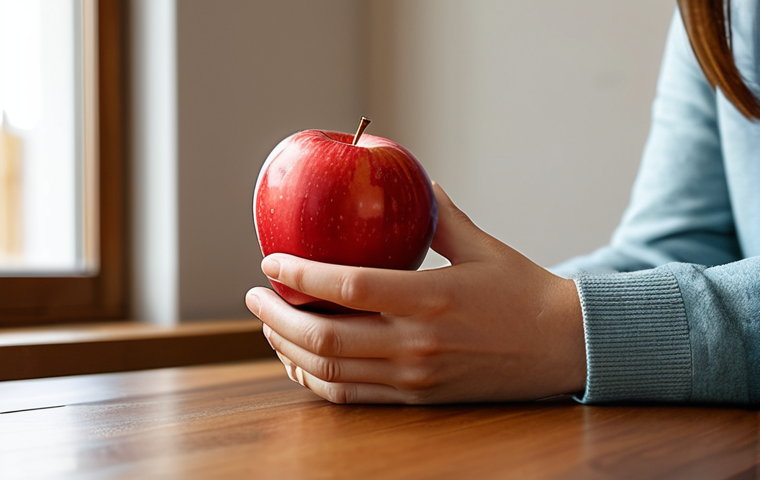 A person, sitting serenely at a wooden dining table, dressed in comfortable, modest clothing and appropriate attire. They are gently holding a vibrant red apple, observing its texture and color with a focused yet peaceful expression. A single bite has been taken, indicating slow, deliberate consumption. Their hands are gracefully positioned, showcasing well-formed hands and proper finger count. The background is a minimalist, warm-toned dining room, bathed in soft natural light from a window, with no electronic devices or distractions visible. Professional photography, high detail, sharp focus, harmonious colors, perfect anatomy, correct proportions, natural pose, safe for work, appropriate content, fully clothed, family-friendly.